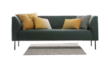 Comfortable green sofa with cushions and rug on white background. Furniture for living room interior