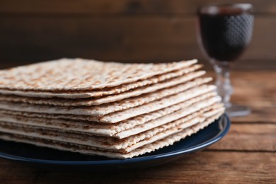 Stack of matzos on wooden table, closeup