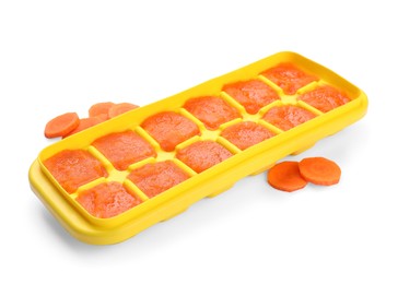 Carrot puree in ice cube tray isolated on white. Ready for freezing