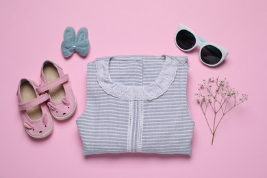 Flat lay composition with stylish child clothes and accessories on pink background