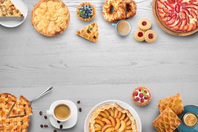 Flat lay composition with different delicious pies on white wooden table. Space for text