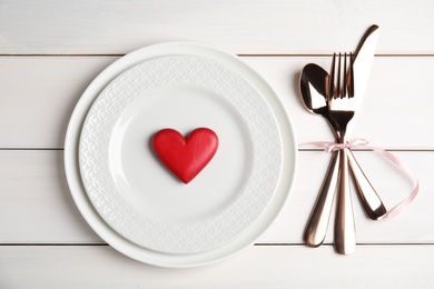 Beautiful place setting for romantic dinner on white table, flat lay. Valentine's day celebration