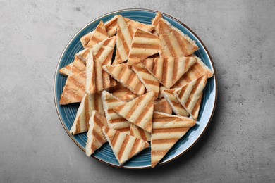 Delicious pita chips on grey table, top view