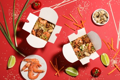 Flat lay composition with noodle wok and ingredients on red background