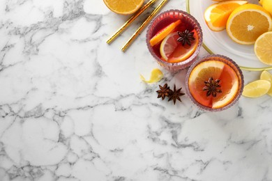 Aromatic punch drink and ingredients on white marble table, flat lay. Space for text