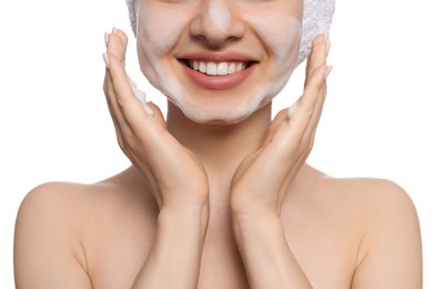 Photo of Young woman washing face with cleansing foam on white background, closeup. Skin care cosmetic
