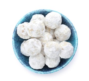 Tasty snowball cookies in bowl isolated on white, top view. Christmas treat