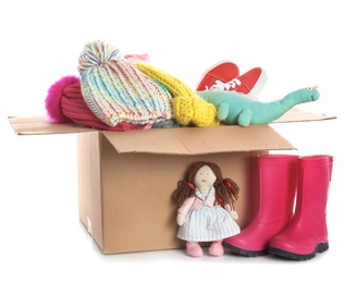 Donation box, shoes, clothes and toys on white background
