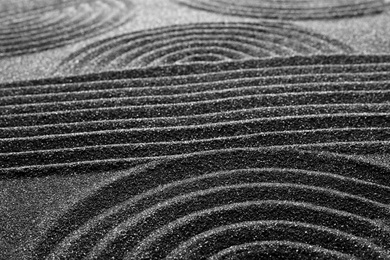Pattern on decorative black sand, closeup. Zen and harmony