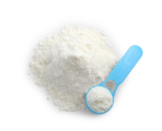 Powdered infant formula and scoop on white background, top view. Baby milk