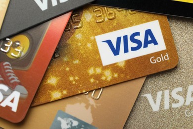 Photo of MYKOLAIV, UKRAINE - FEBRUARY 23, 2022: Bank cards of Visa payment system, closeup