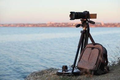 Professional photography equipment on rocky river coast