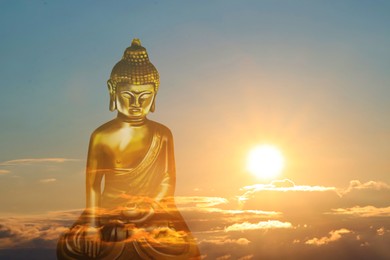 Golden Buddha sculpture and beautfiful sky at sunset on background