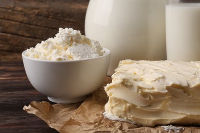 Photo of Tasty homemade butter and dairy products on wooden table, closeup