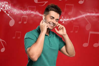 Image of Happy man listening to music on red background. Music notes illustrations flowing from earphones