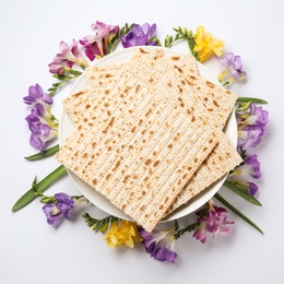 Composition of matzo and flowers on light background, top view. Passover (Pesach) Seder