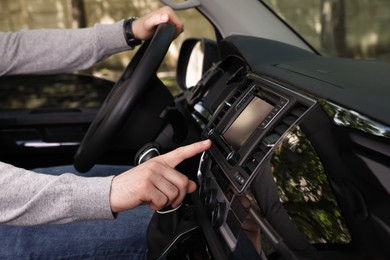 Driver using modern car navigation system, closeup