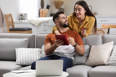 Young couple discussing family budget at home