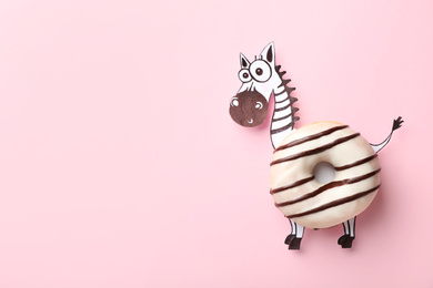 Funny zebra made with donut and piece of paper on pink background, top view. Space for text