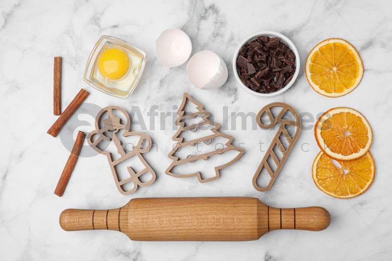 Photo of Flat lay composition with cookie cutters and ingredients on white marble table