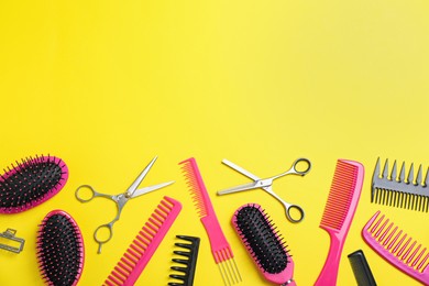Flat lay composition with professional scissors and other hairdresser's equipment on yellow background, space for text. Haircut tool