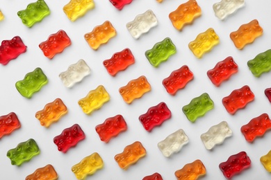 Delicious color jelly bears on white background, top view