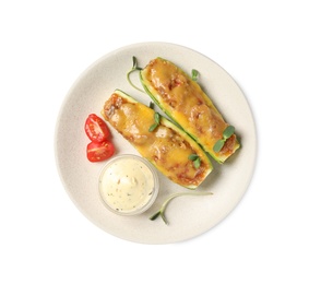 Baked stuffed zucchinis with sauce and tomatoes on white background, top view