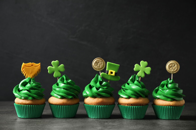 Delicious decorated cupcakes on grey table. St. Patrick's Day celebration