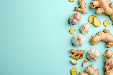 Photo of Ginger and garlic on turquoise table, flat lay with space for text. Natural cold remedies