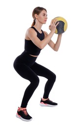 Athletic woman doing squats with medicine ball isolated on white