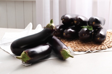 Many raw ripe eggplants on light table