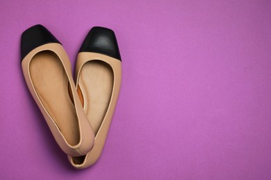 Photo of Pair of new stylish square toe ballet flats on purple background, flat lay. Space for text