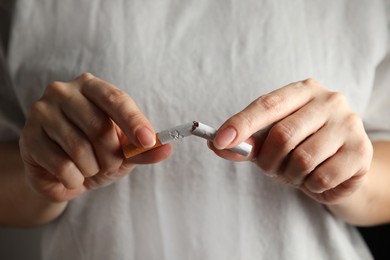 Woman breaking cigarette, closeup. Quitting smoking concept