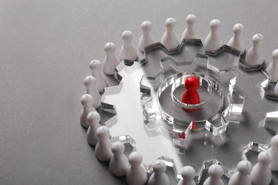 Photo of Employee selection process. Composition with cogwheels, red pawn as recruiter and white ones as applicants on light grey background. Space for text