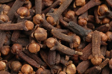Aromatic dry cloves as background, closeup view