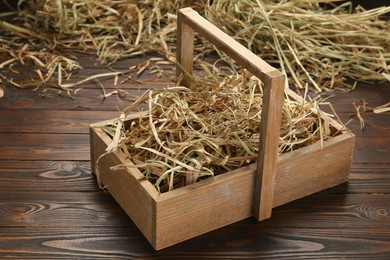 Dried hay in crate on wooden table