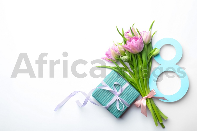 Photo of 8 March greeting card design with tulips and gift on white background, top view. Space for text