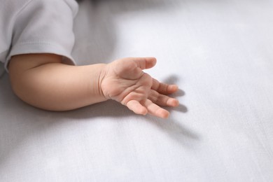 Photo of Little baby on bed, closeup. Space for text
