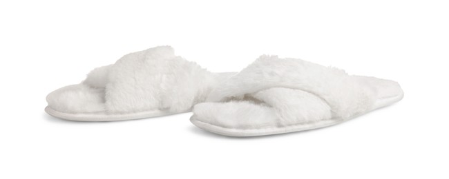 Pair of soft fluffy slippers on white background