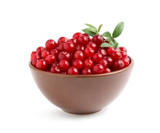Photo of Fresh ripe cranberries with leaves in bowl isolated on white
