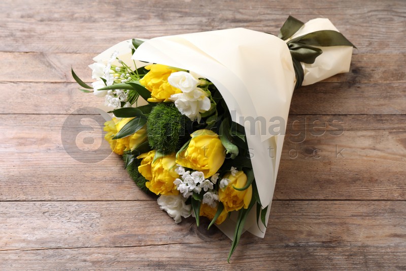 Beautiful bouquet with peony tulips on wooden table