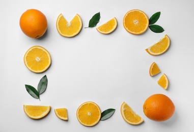 Frame made of fresh oranges on white background, top view with space for text