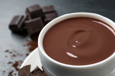 Yummy hot chocolate in cup on table, closeup