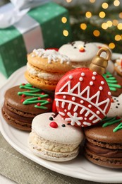 Beautifully decorated Christmas macarons on table, closeup