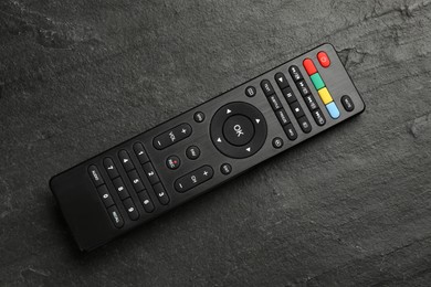 Modern tv remote control on black table, top view