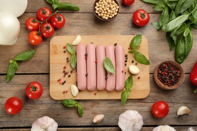 Flat lay composition with raw vegetarian sausages on wooden table