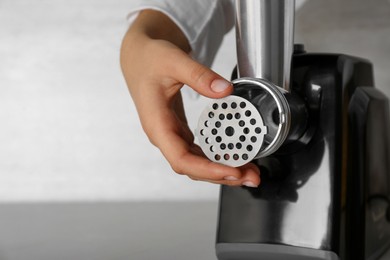 Photo of Woman assembling electric meat grinder, closeup. Space for text