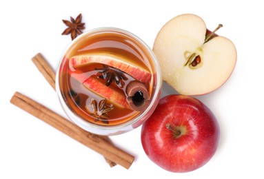 Hot mulled cider and ingredients on white background, top view