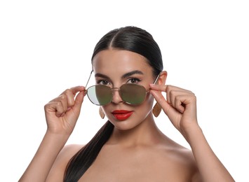 Attractive woman wearing fashionable sunglasses on white background