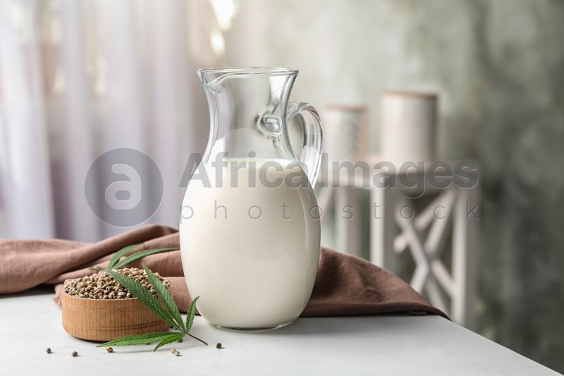 Composition with hemp milk on white table indoors